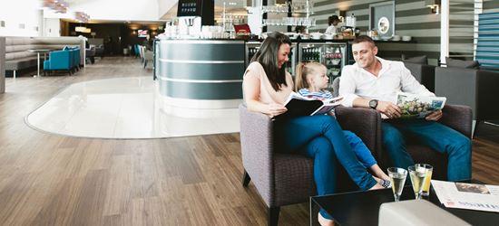 A family reading at the Manchester Terminal 1 Aspire Lounge