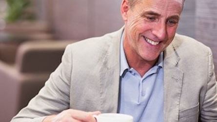Man drinking coffee in an Aspire Lounge