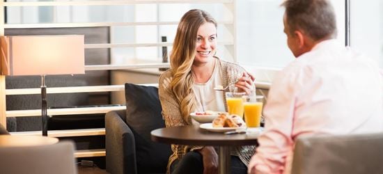 Couple sat in Birmingham Airport's Aspire Lounge