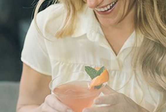 Woman with cocktail smiling