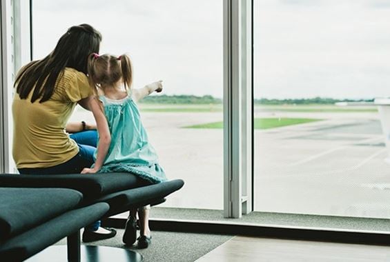 Mother showing her daughter the aeroplanes