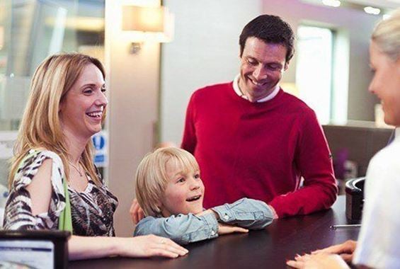 Family checking into an executive lounge