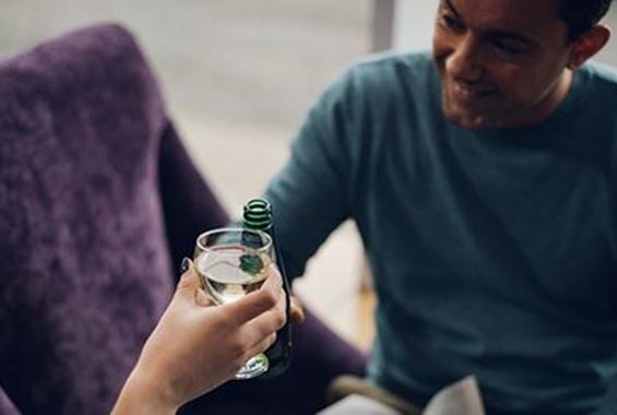 Man toasting with woman