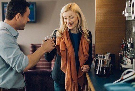 Man and woman enjoying drink at one of our lounges